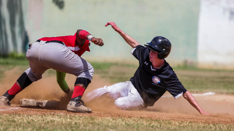 player sliding into base in a game of baseball